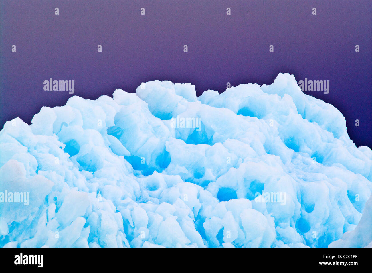 Razor serrations and erosion on the edge of an iridescent blue iceberg Stock Photo