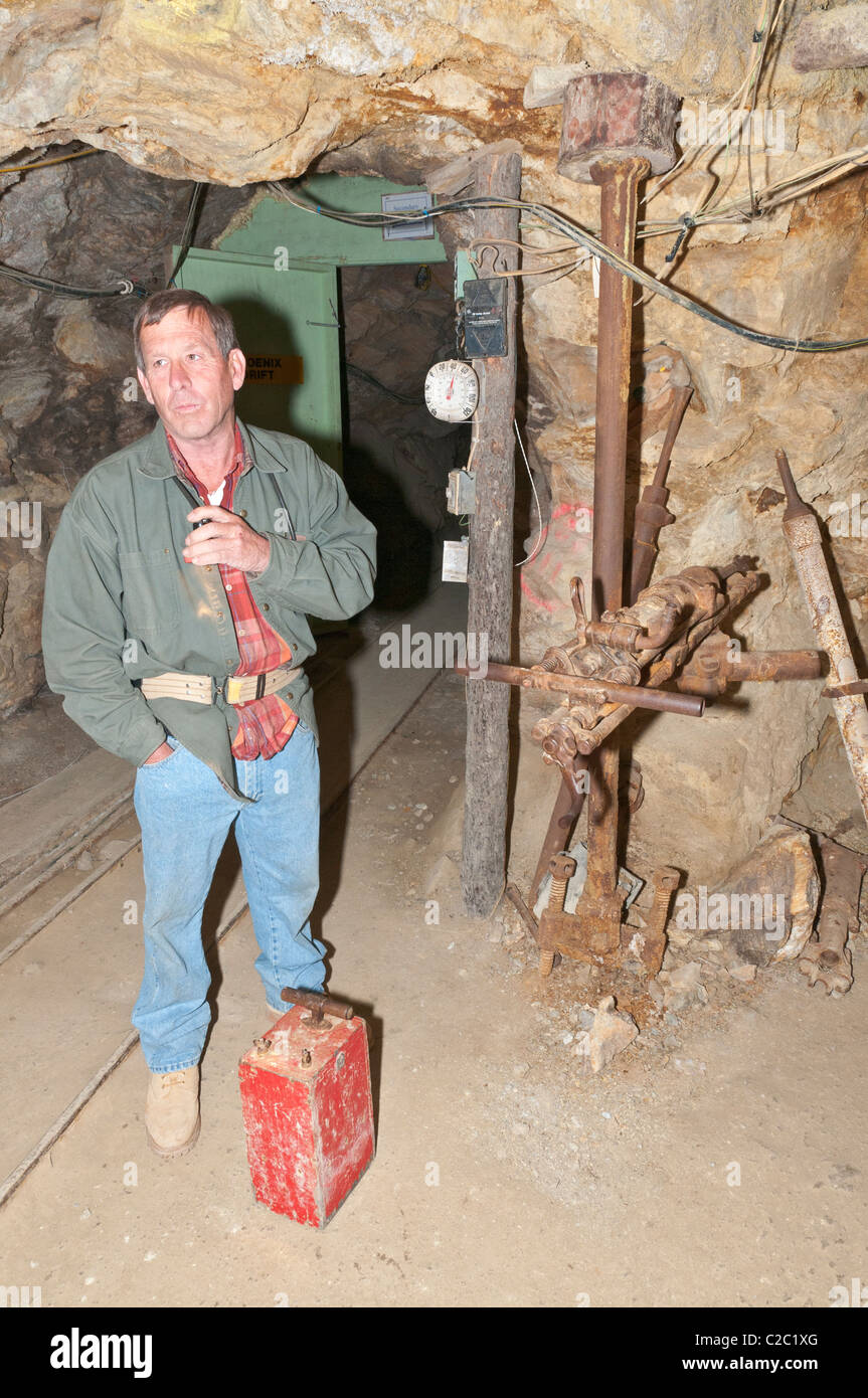 Colorado, Idaho Springs, Phoenix Gold Mine, miner leading underground tour explains old mining equipment Stock Photo