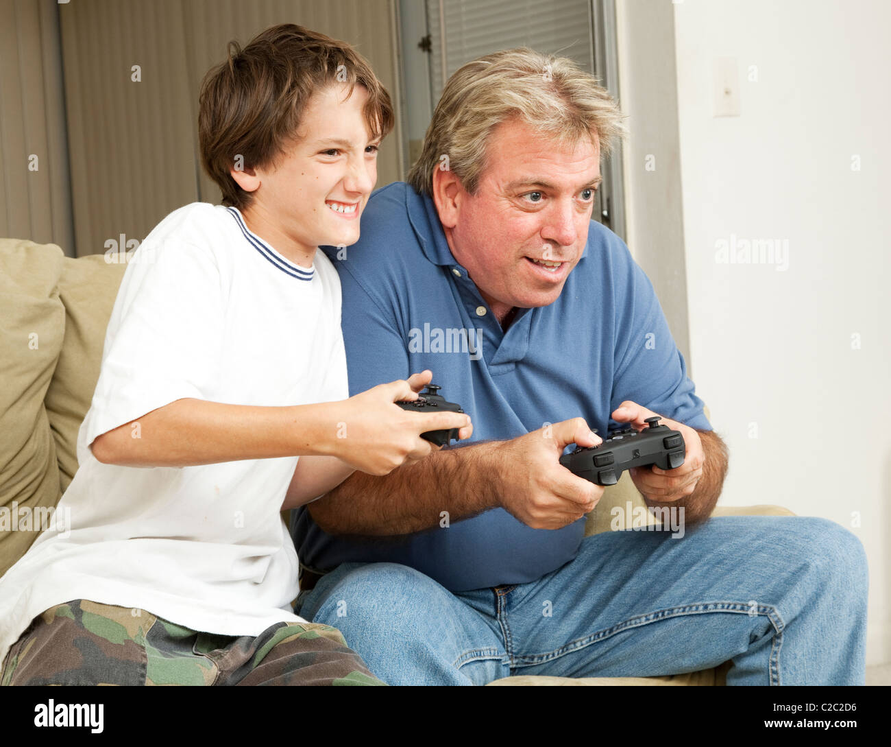 Father or uncle playing video games with a little boy - his son or nephew  Stock Photo - Alamy