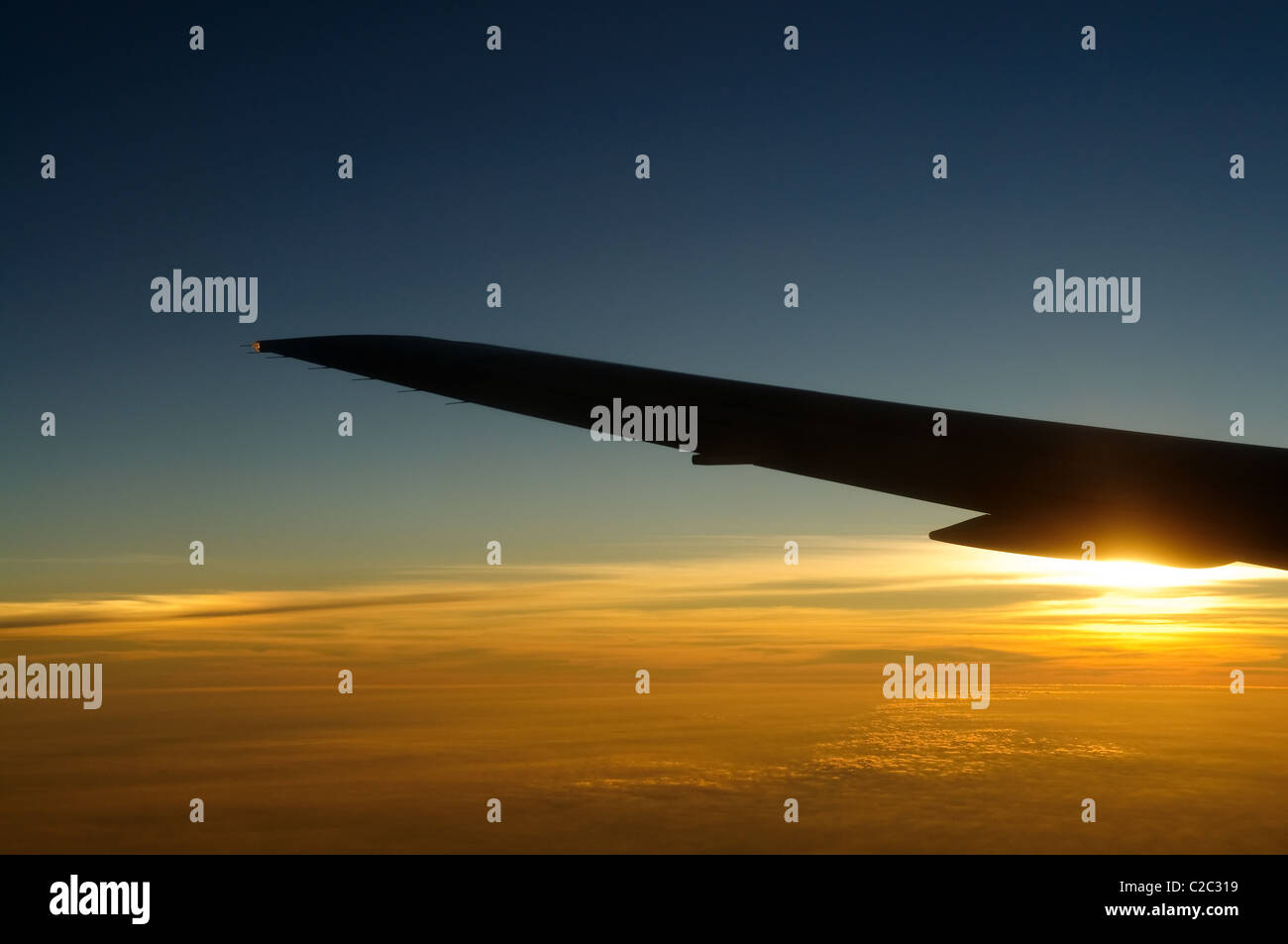 Sunset under airplane wing skyline Stock Photo