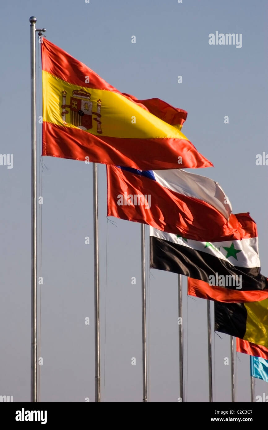 Bright and colorful flags of several nations, including Chile, Spain and Iraq are flying in Phnom Penh, Cambodia. Stock Photo