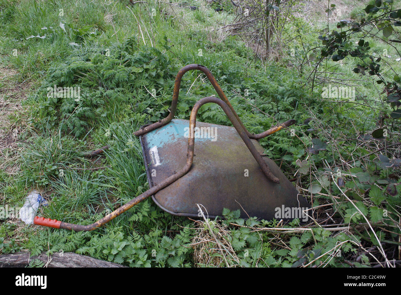 old rusty wheelbarrow in field in Worksop, Notts, England Stock Photo