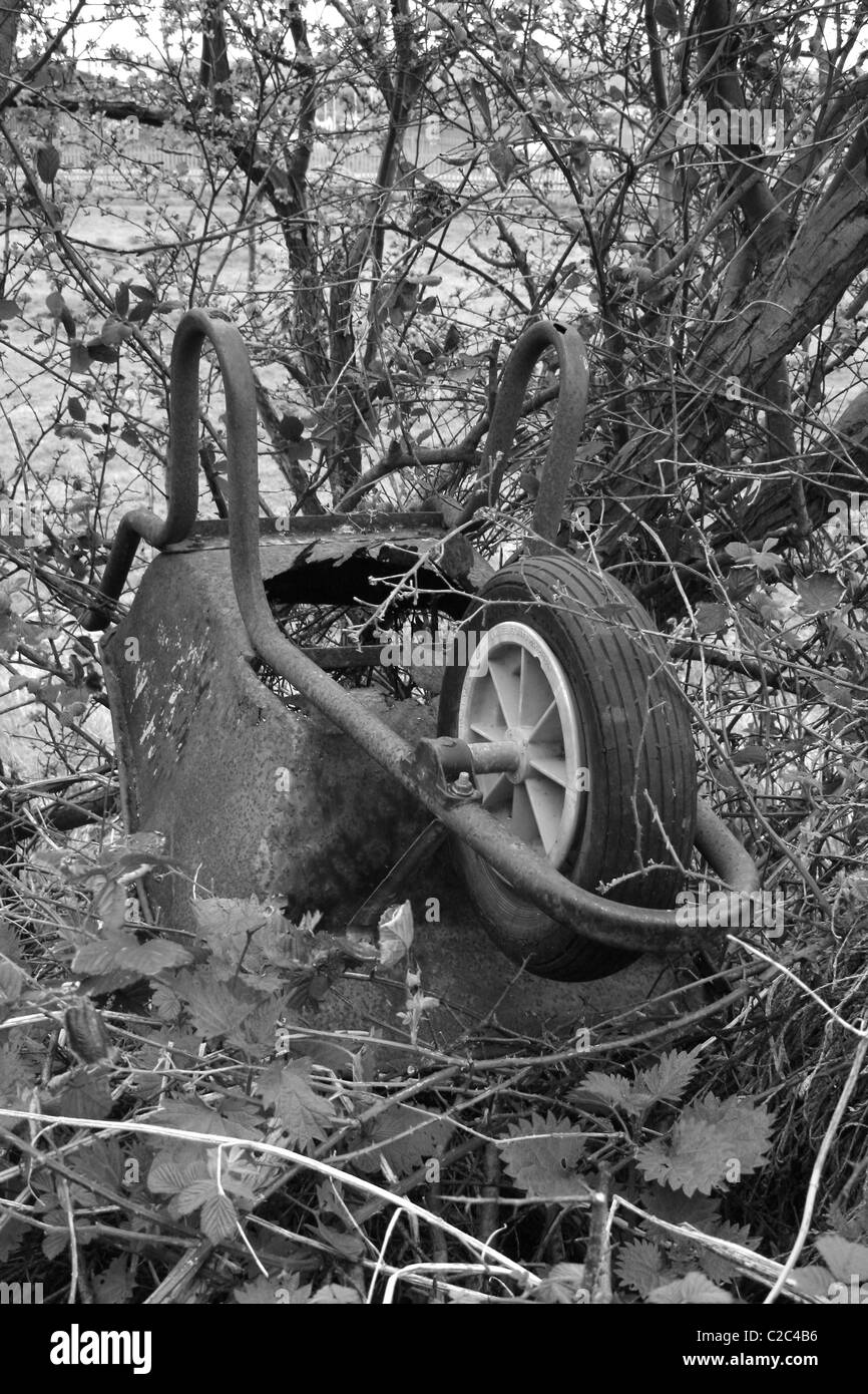 old rusty wheelbarrow in field in Worksop, Notts, England Stock Photo