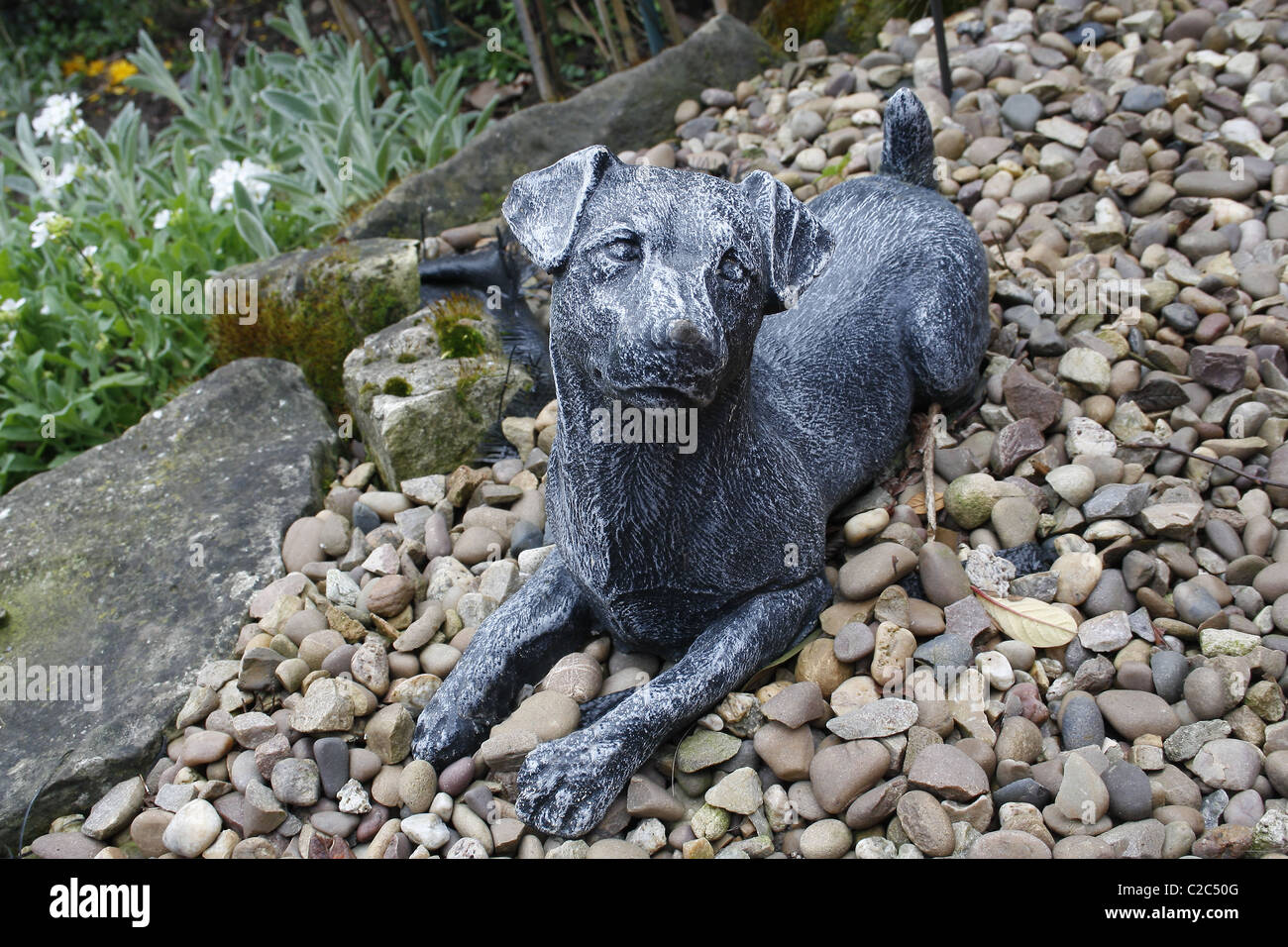 dog statue on gravel Stock Photo Alamy
