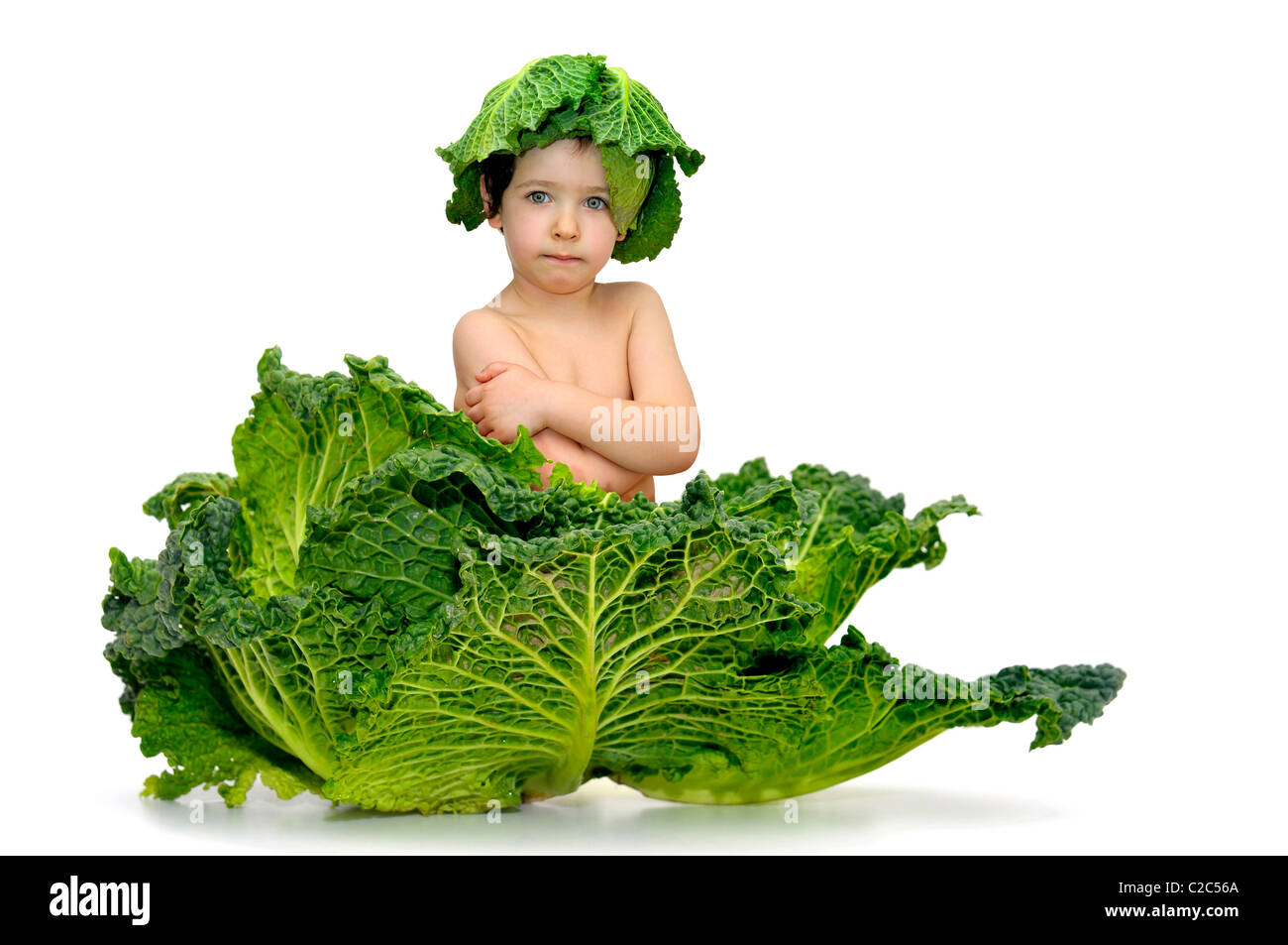 Beautiful young boy inside a cabbage Stock Photo