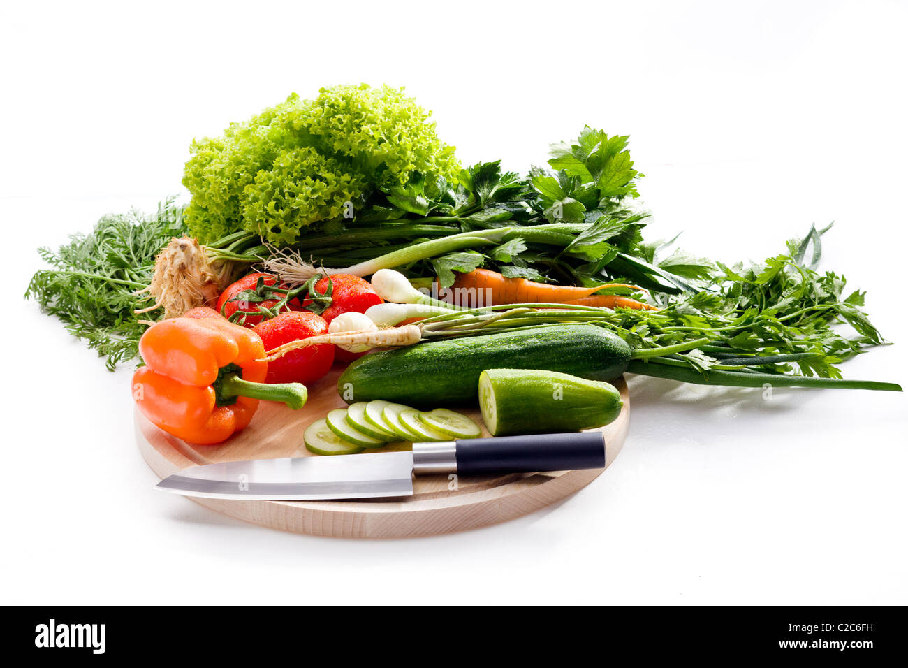 Raw vegetables on cutting board on white background Stock Photo