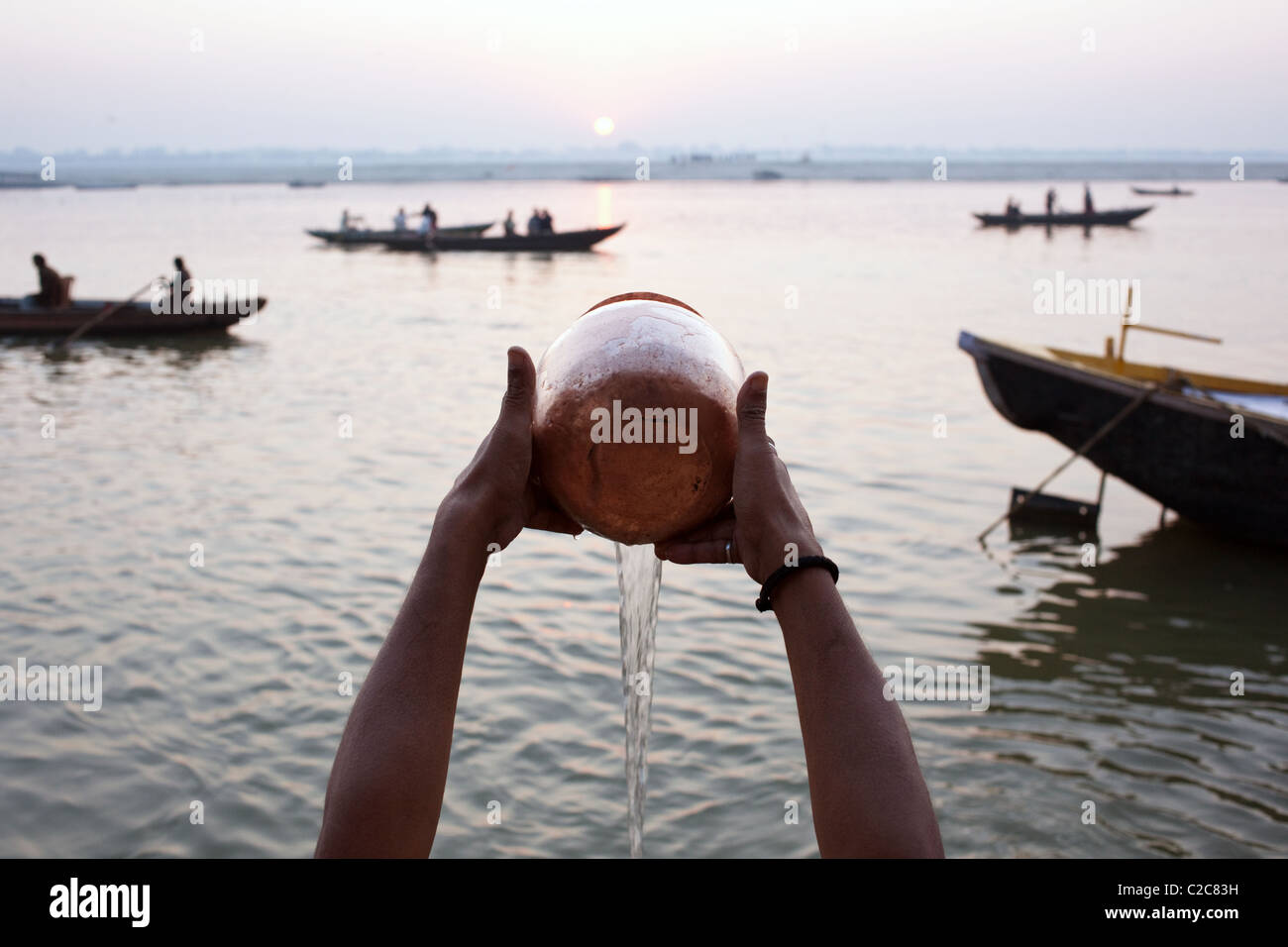 A brahmin prays at sunrise on Ganges river in Varanasi (Benares), Uttar Pradesh state, India. Stock Photo