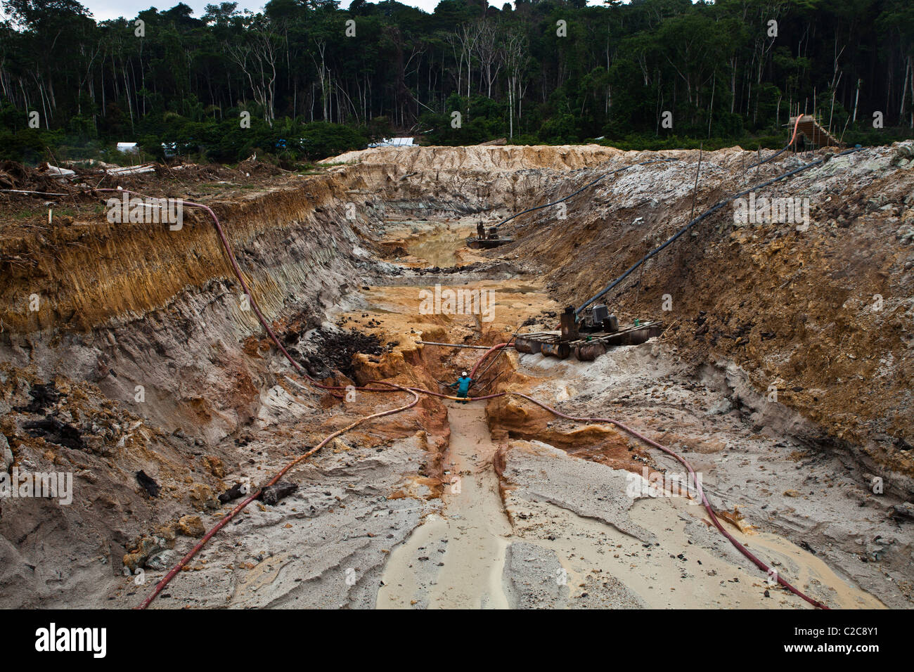Hydraulic gold mining in Amazon rain forest Brazil Large and deep holes are made in forest land chupadeira system Stock Photo