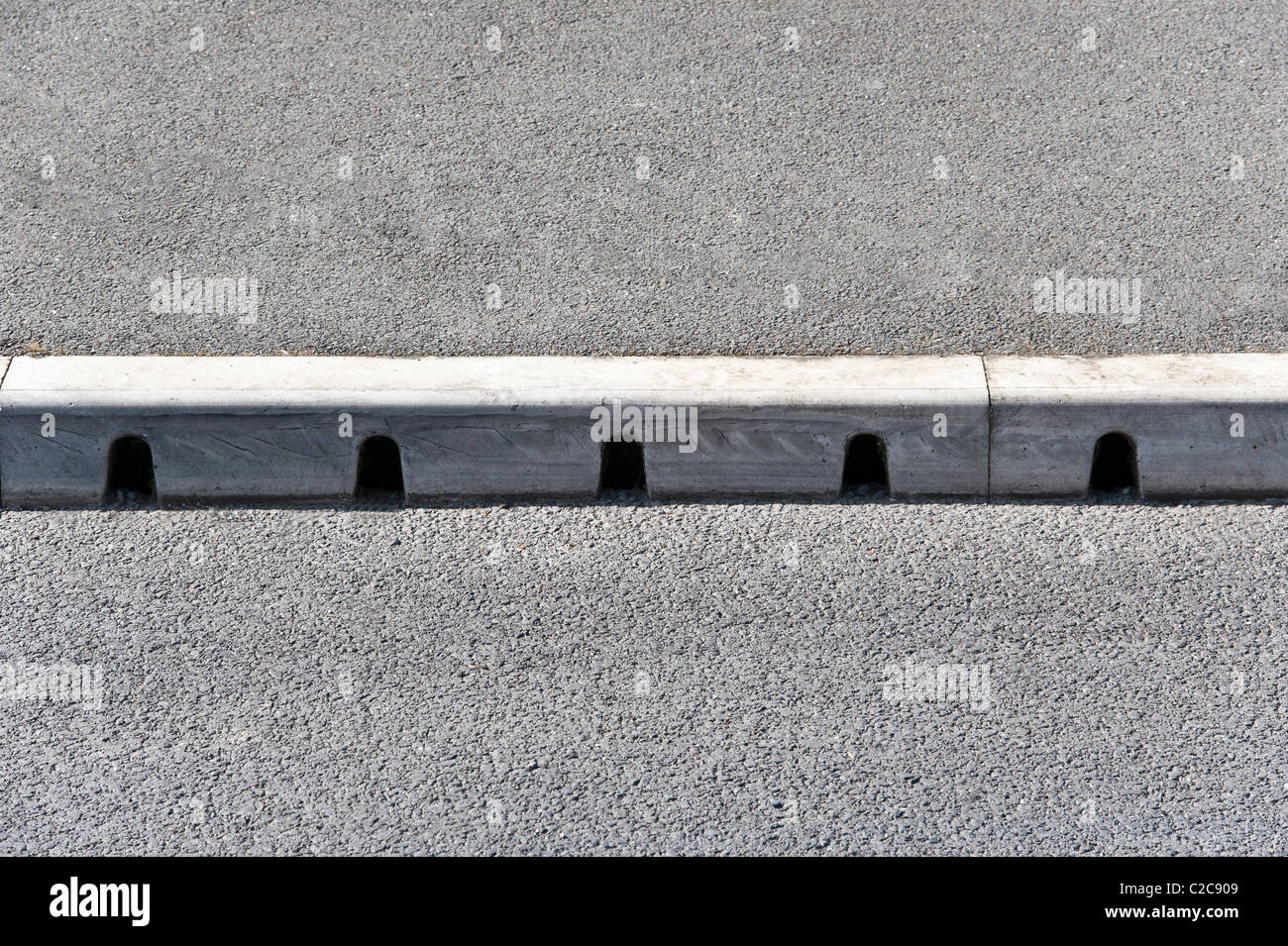 Kerb drain installed at the side of a residential street. This allows