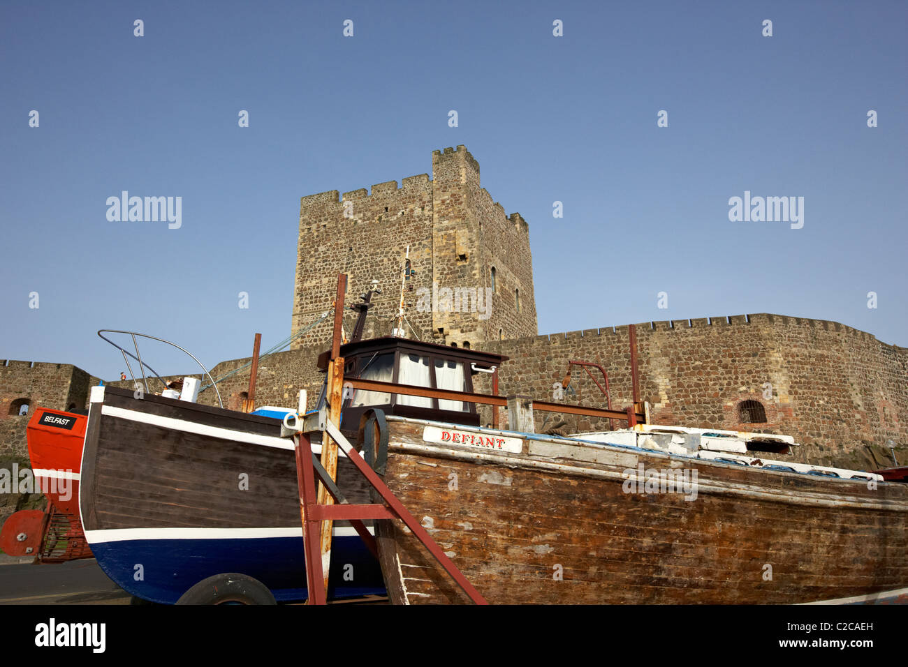 old fishing boats in front of carrickfergus castle in northern ireland Stock Photo