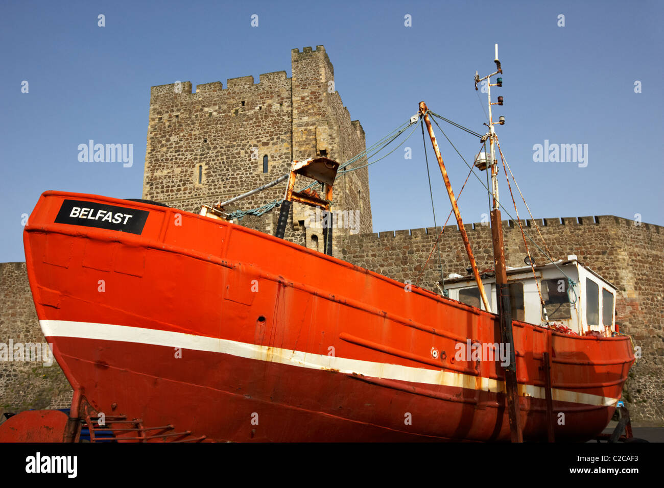 old fishing boat in front of carrickfergus castle in northern ireland Stock Photo