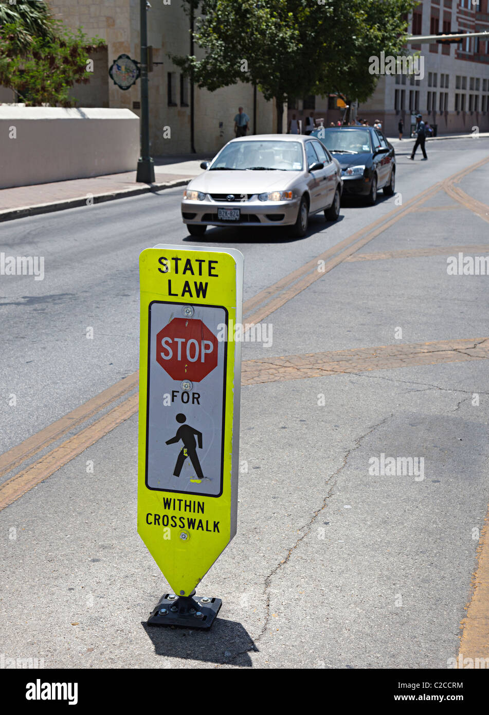 State law stop for pedestrians within crosswalk sign in road San