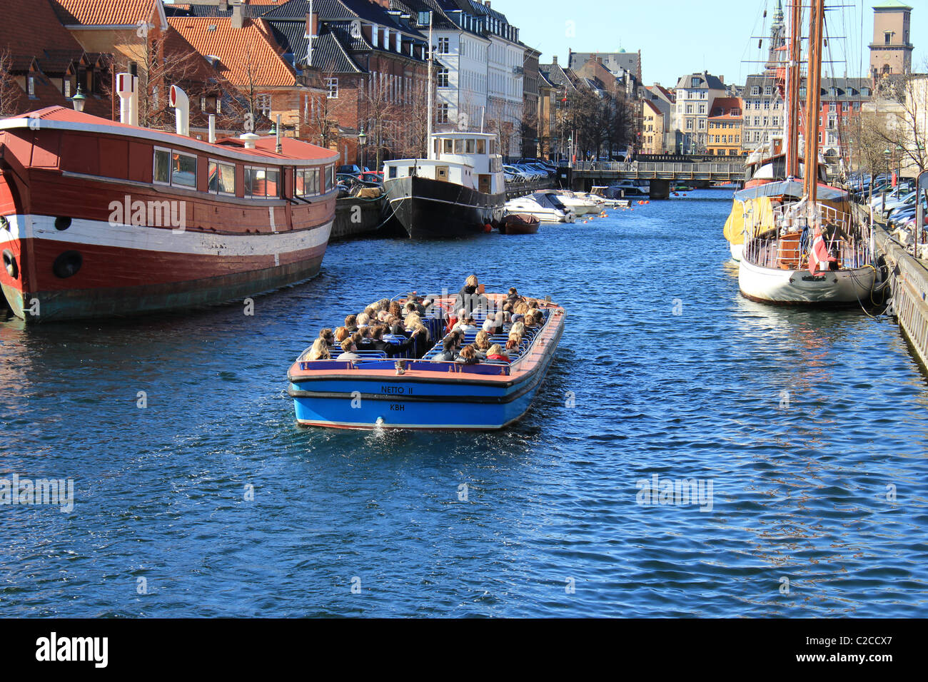 At springtime one of the first top-open tourist boats on canals in Copenhagen Stock Photo