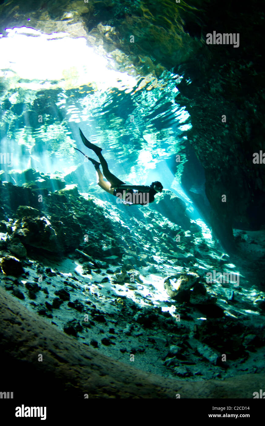 A freediver at an entrance of a cenote in Mexico Stock Photo
