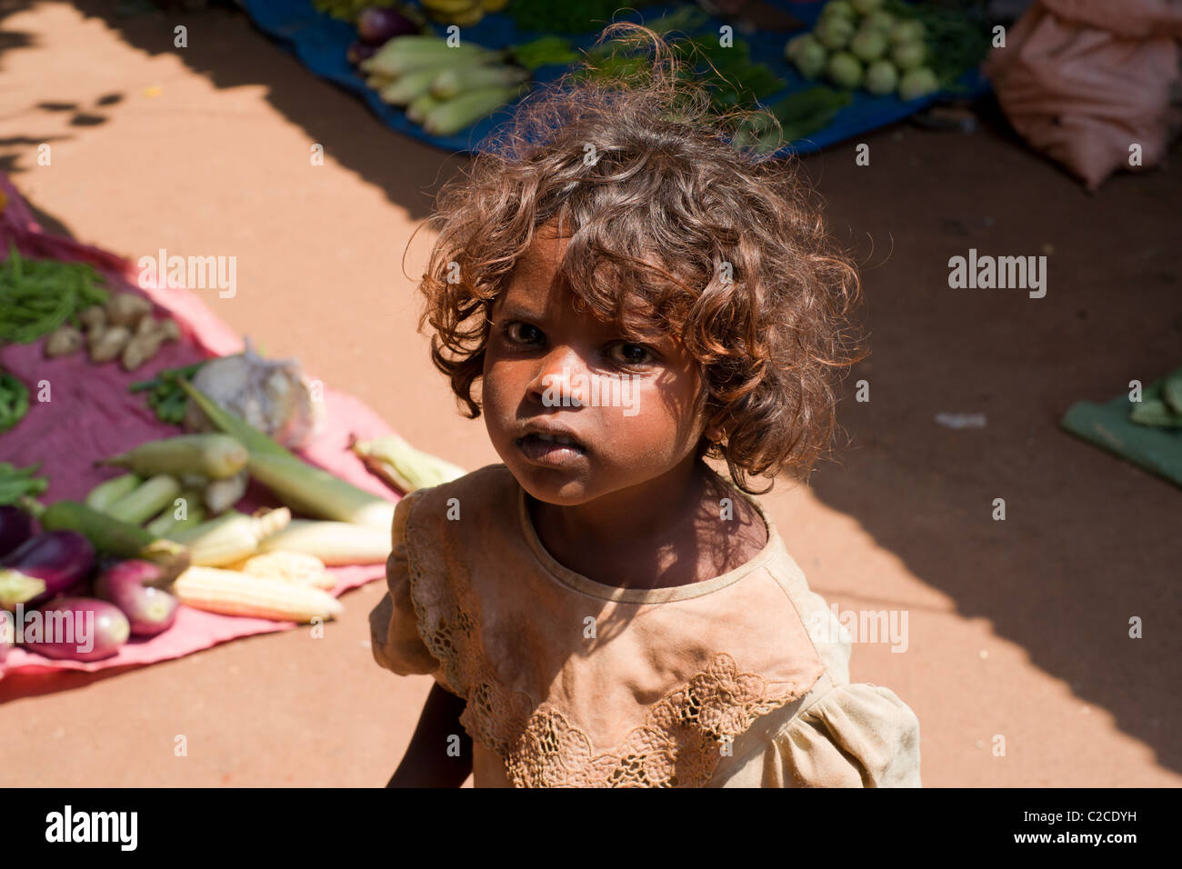 A young female child begging in Calangute food market, Goa, India Stock Photo