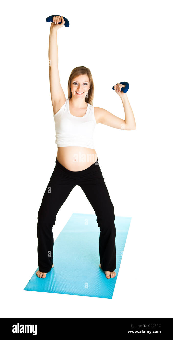 Caucasian blond 6th month pregnant young adult woman excercises fitness