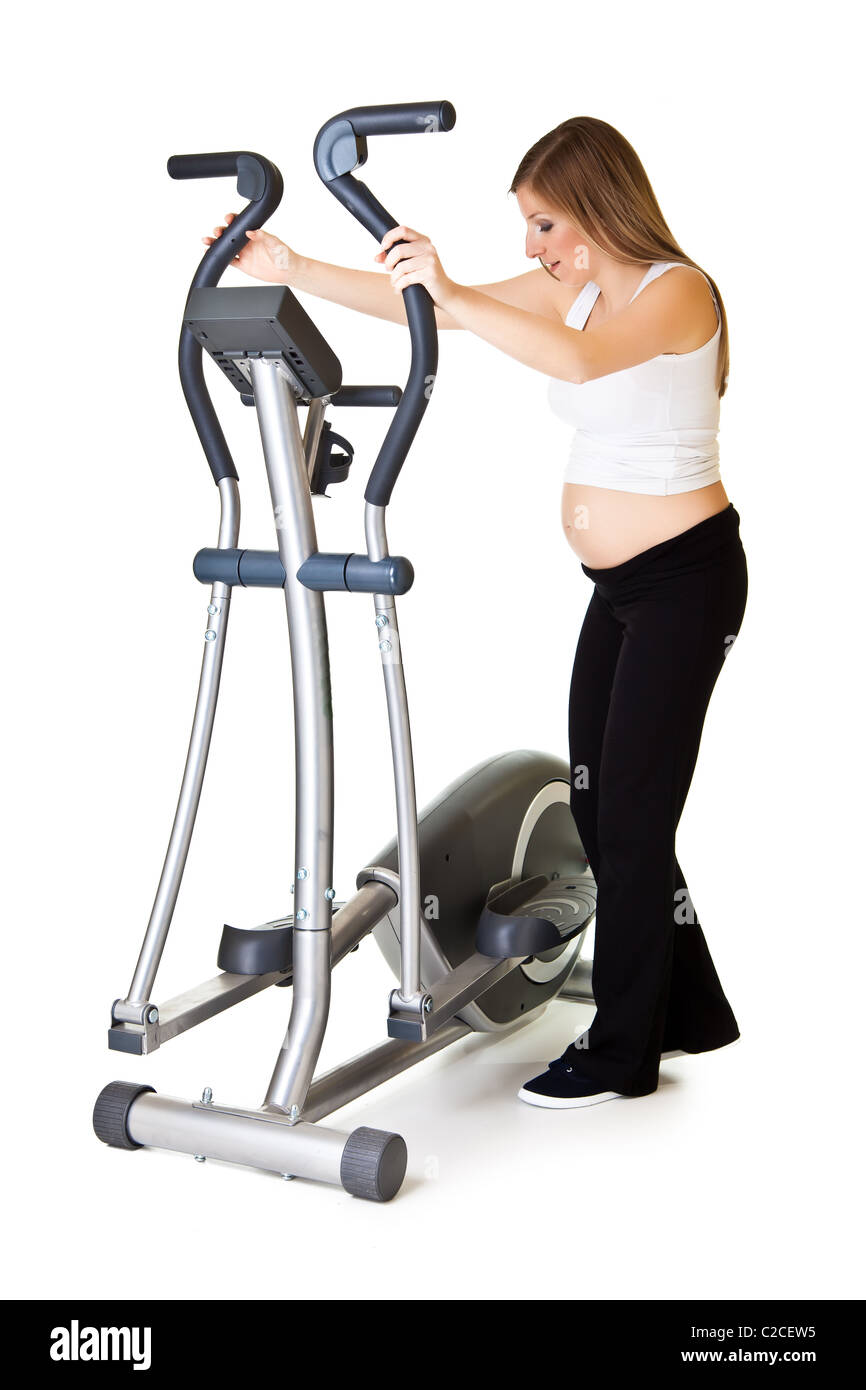 Caucasian blond 6th month pregnant young adult woman excercises fitness