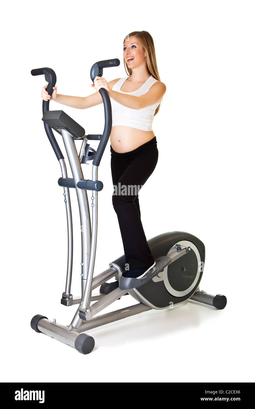 Caucasian blond 6th month pregnant young adult woman excercises fitness