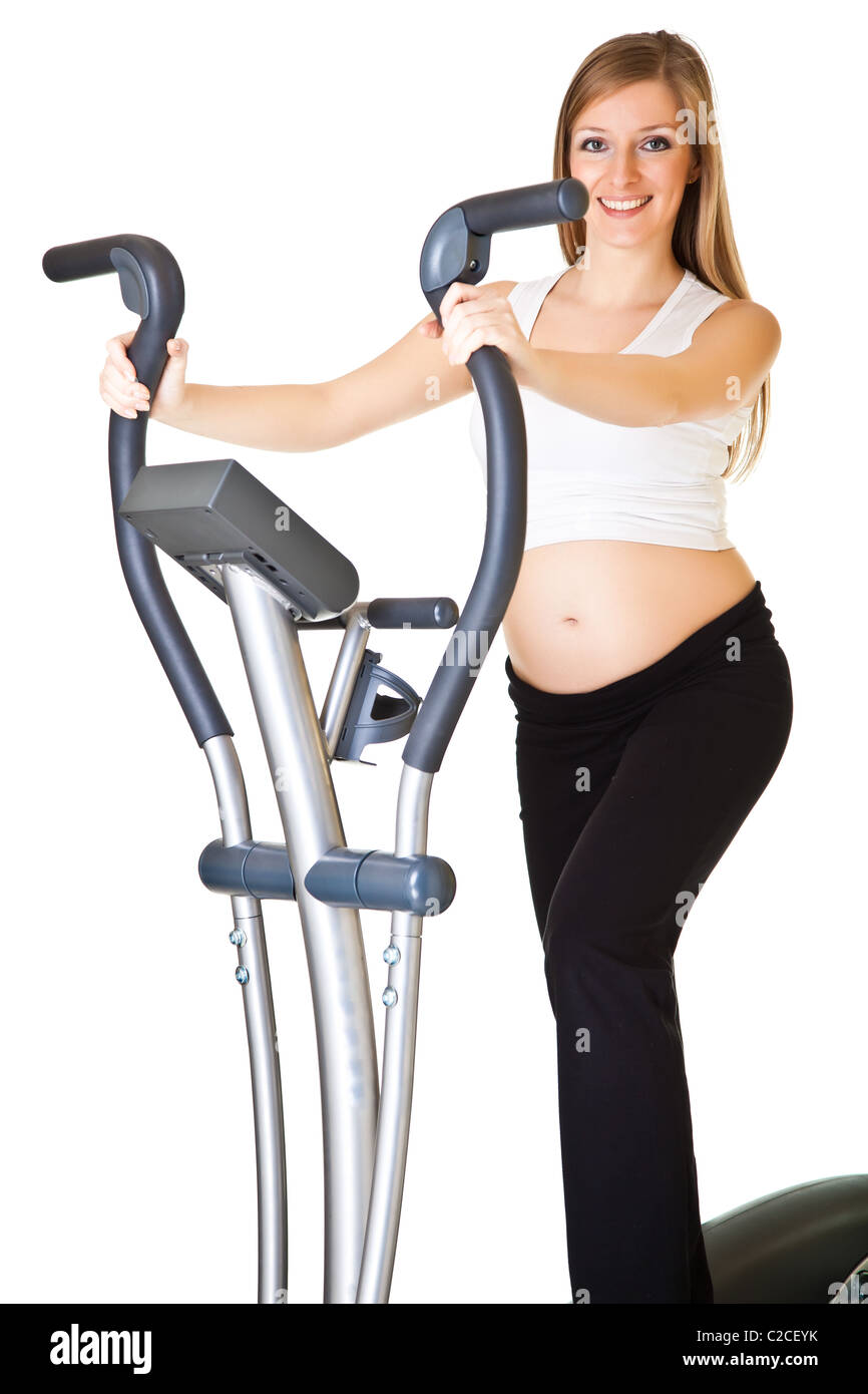 Caucasian blond 6th month pregnant young adult woman excercises fitness on white isolated background Stock Photo