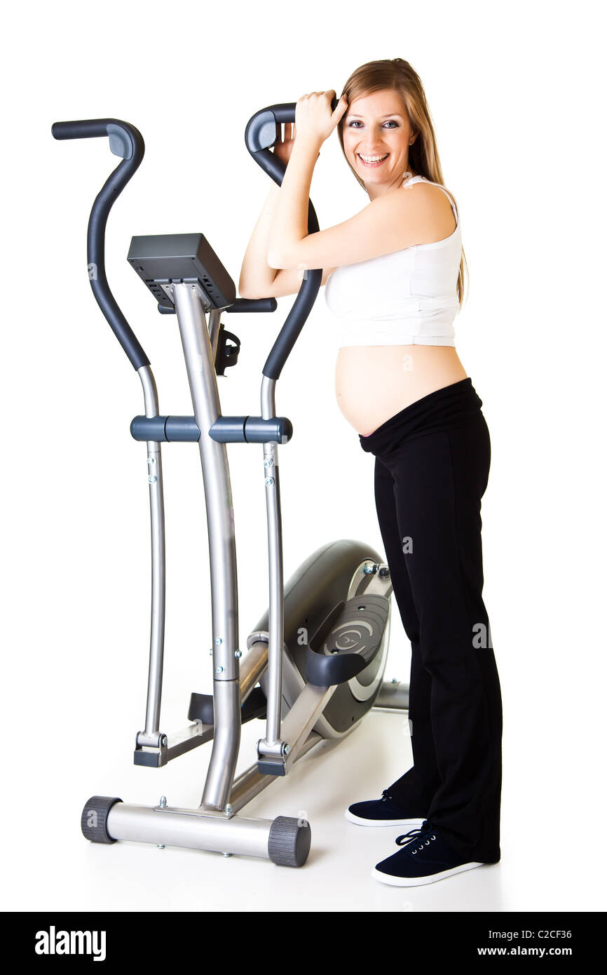 Caucasian blond 6th month pregnant young adult woman excercises fitness