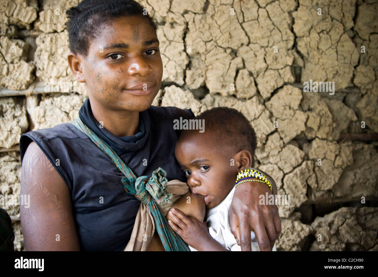 A pygmy breastfeeding her baby in a refugee camp ,Betou ,Ubangi River ...