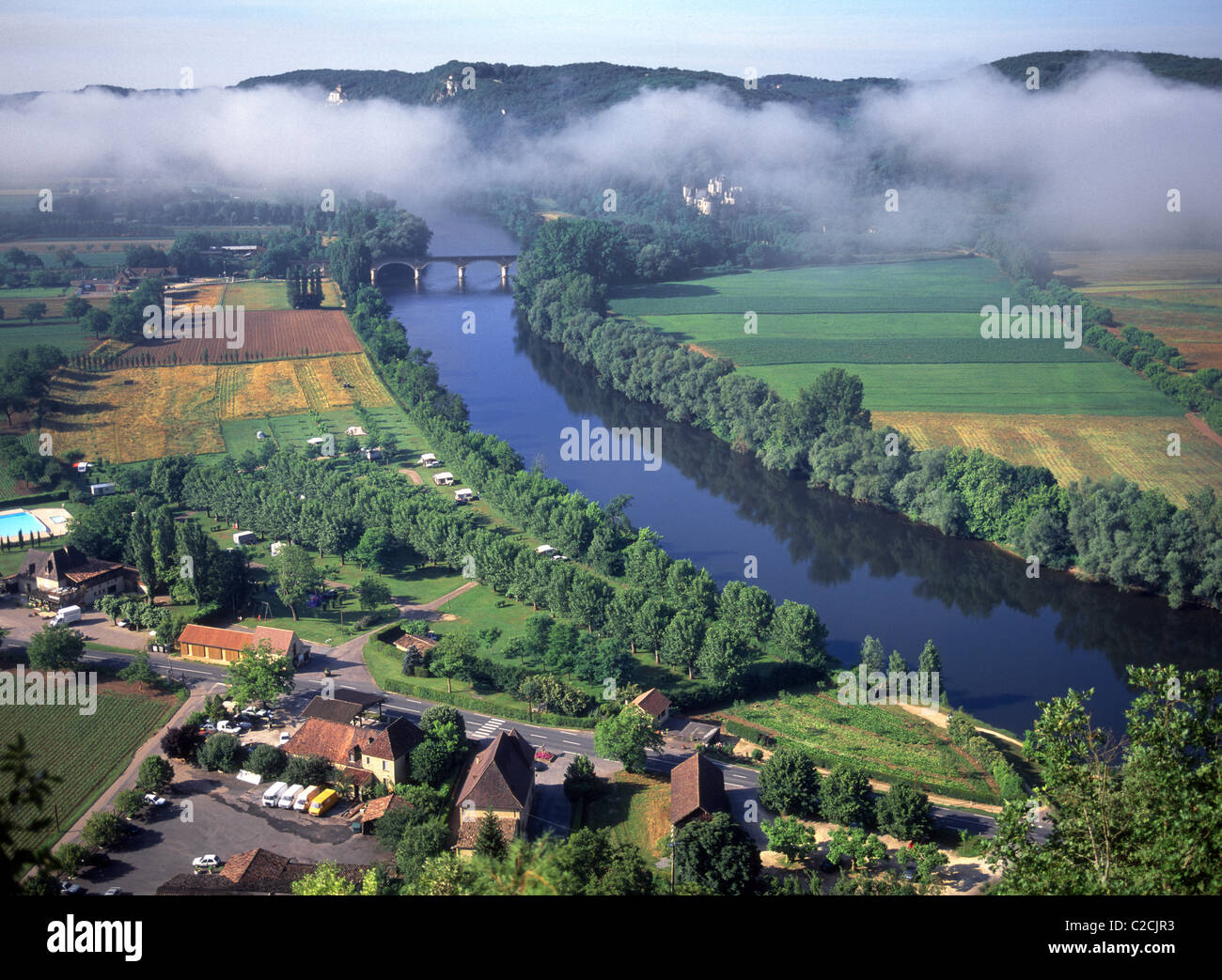 Aerial view of French agriculture farmland in countryside landscape with mist low cloud over the Dordogne river at Domme Dordogne Perigord France Stock Photo