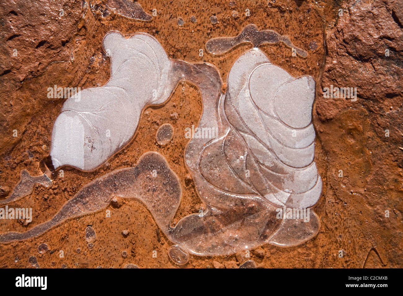 Water freezes in artistic shapes on the rocks in Sedona, Arizona. Stock Photo