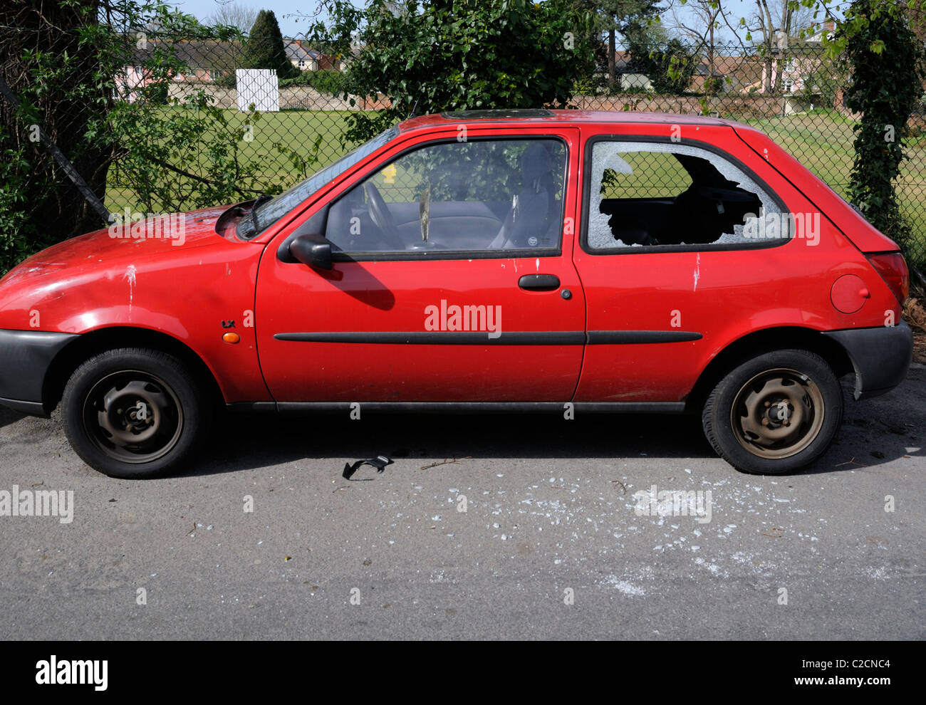 A car with a rear side window broken by 'smash and grab' thieves. Stock Photo