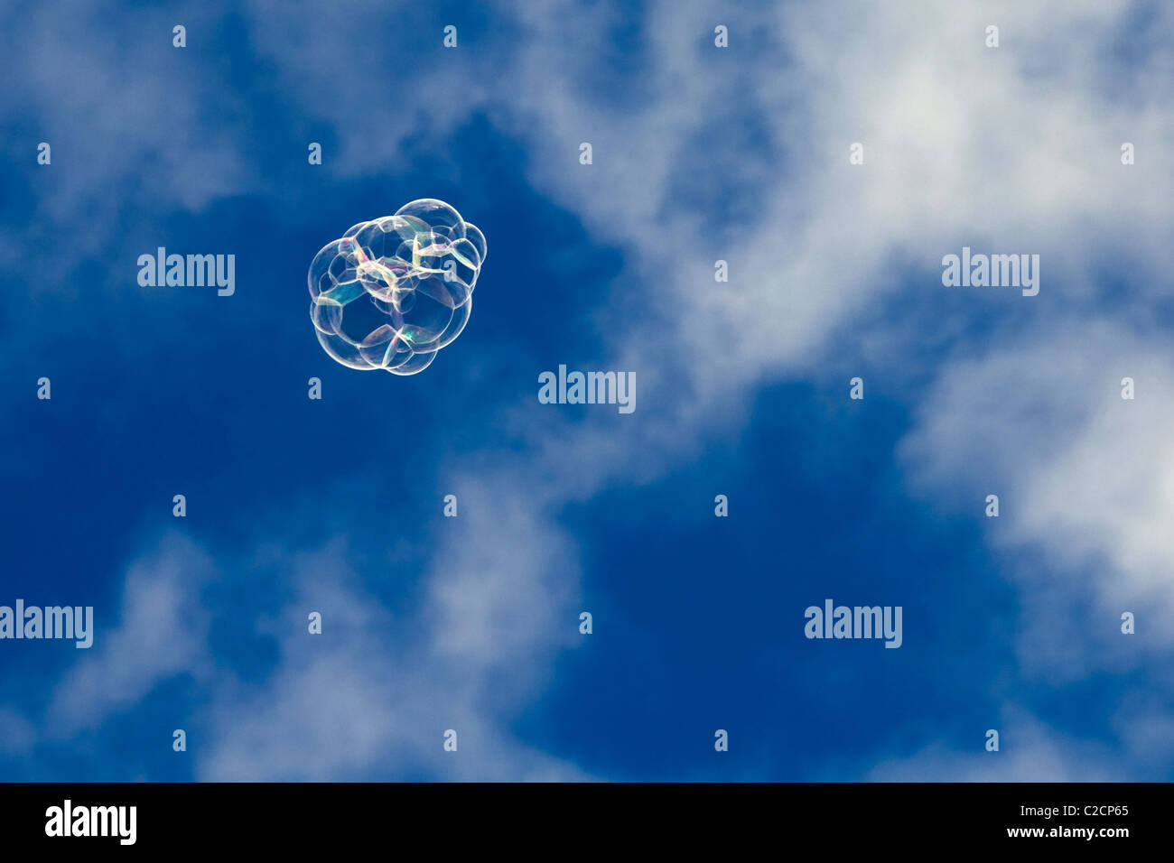 Cluster of bubbles floating in a blue sky with some cloud Stock Photo ...
