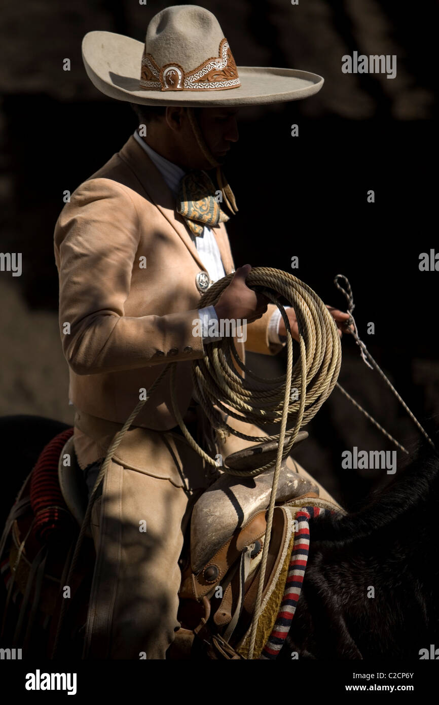 A Mexican Charro holds his lasso during a charreria exhibition in Mexico City, Mexico Stock Photo