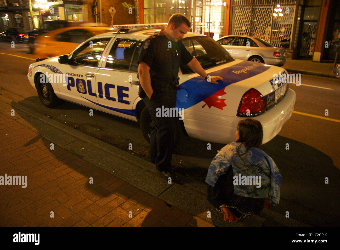 Vancouver police with handcuffed prisoner in Gastown, Vancouver