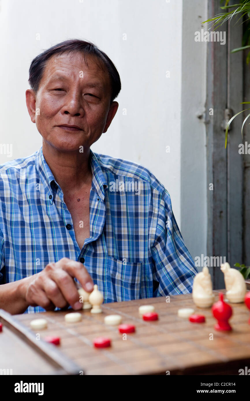 Local Thai people play old traditional Thai chess in public area - slow  life style local people with chess board game concept Stock Photo