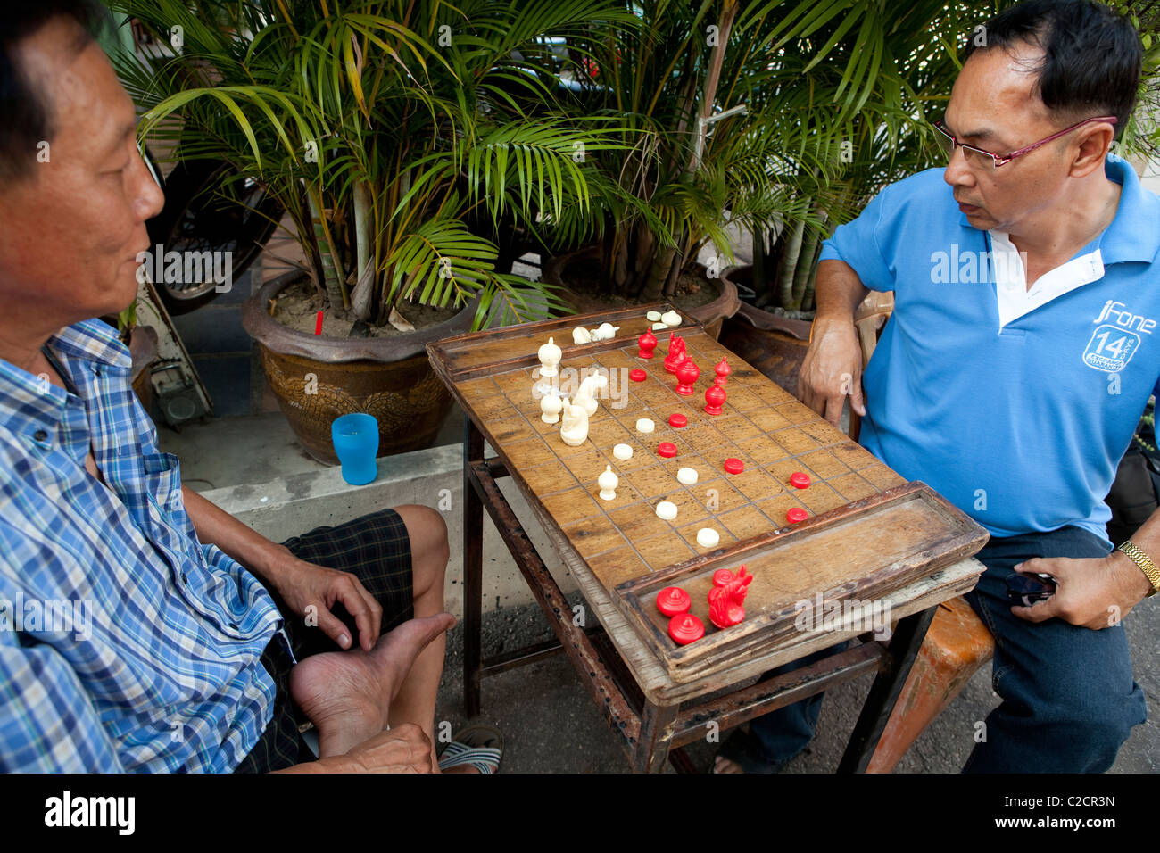 Local Thai people play old traditional Thai chess in public area - slow  life style local people with chess board game concept Stock Photo