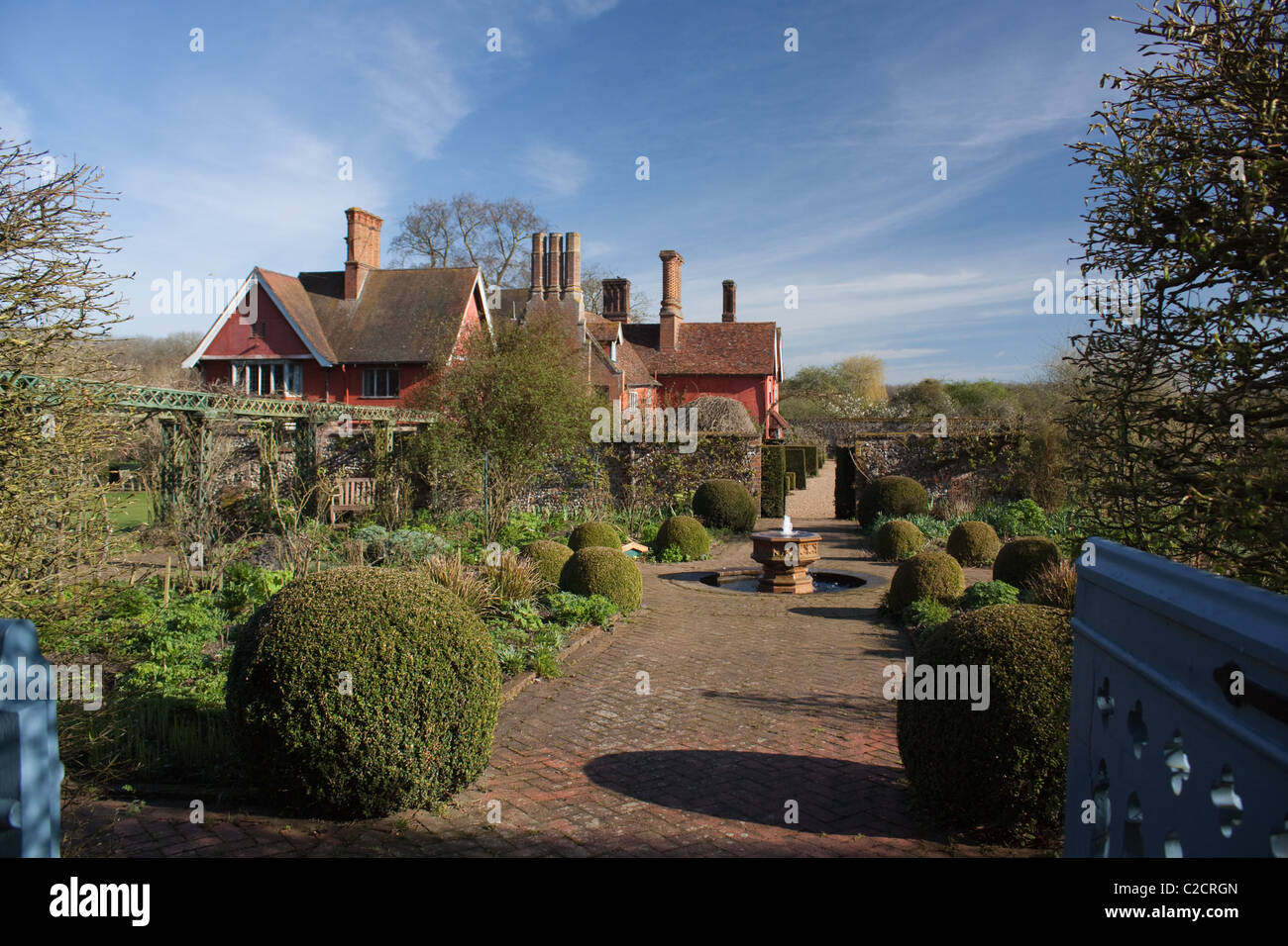 Looking through a gate into the Rose Garden at Wyken Hall, Suffolk, in