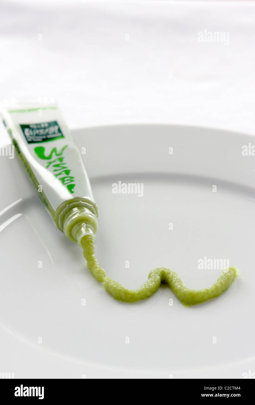 Tube of wasabi with the paste forming a w on a plate Stock Photo