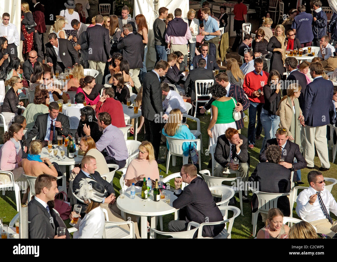 People at a bar being sociable, dining and drinking during Henley Royal Regatta on the River Thames, England Stock Photo