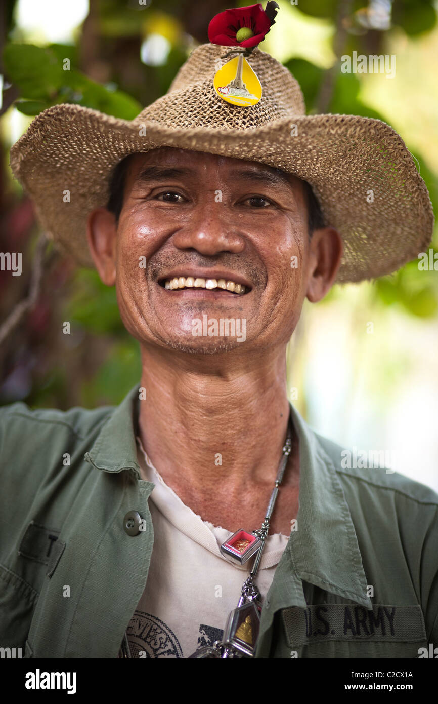Thai ex-serviceman wearing a lot of Phra (Thai amulet) with smile. Lampang Thailand Stock Photo