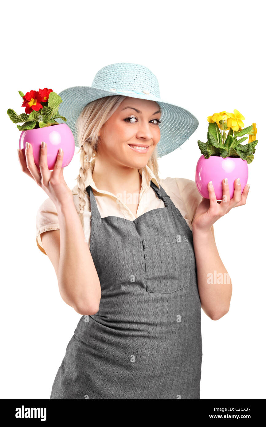 A smiling female gardener holding two potted plants Stock Photo - Alamy