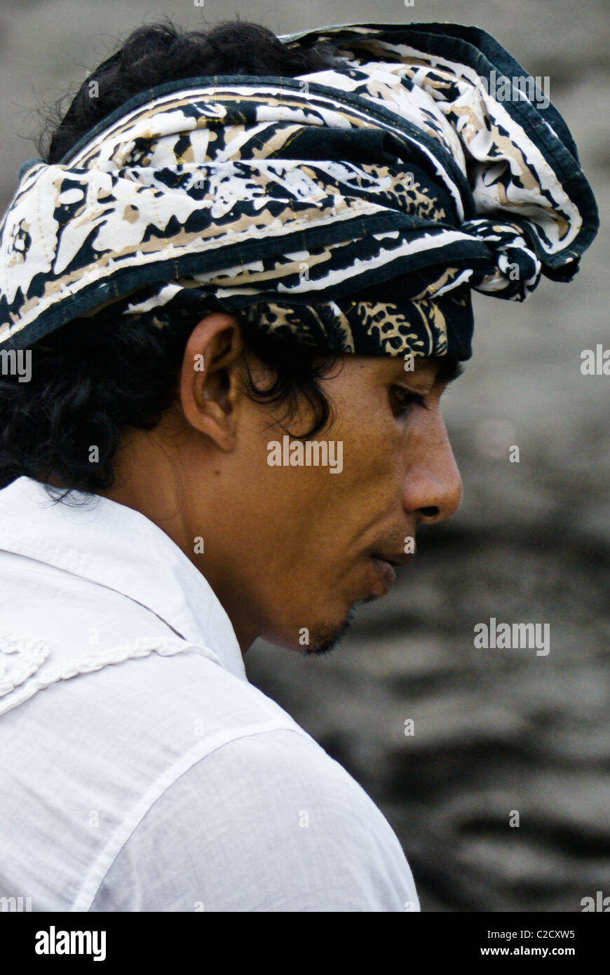 Balinese man wearing traditional batik head scarf, Bali, Indonesia Stock Photo