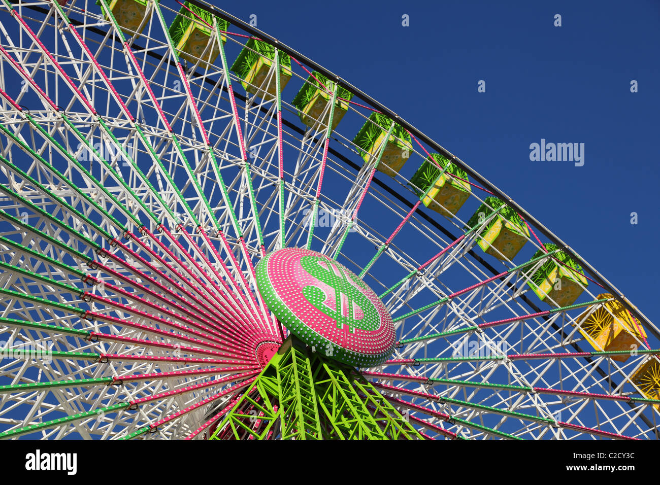 Colorful ferris wheel against blue sky Stock Photo - Alamy