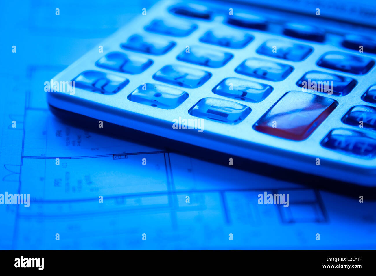 Calculator on blueprints - home buying concept Stock Photo - Alamy
