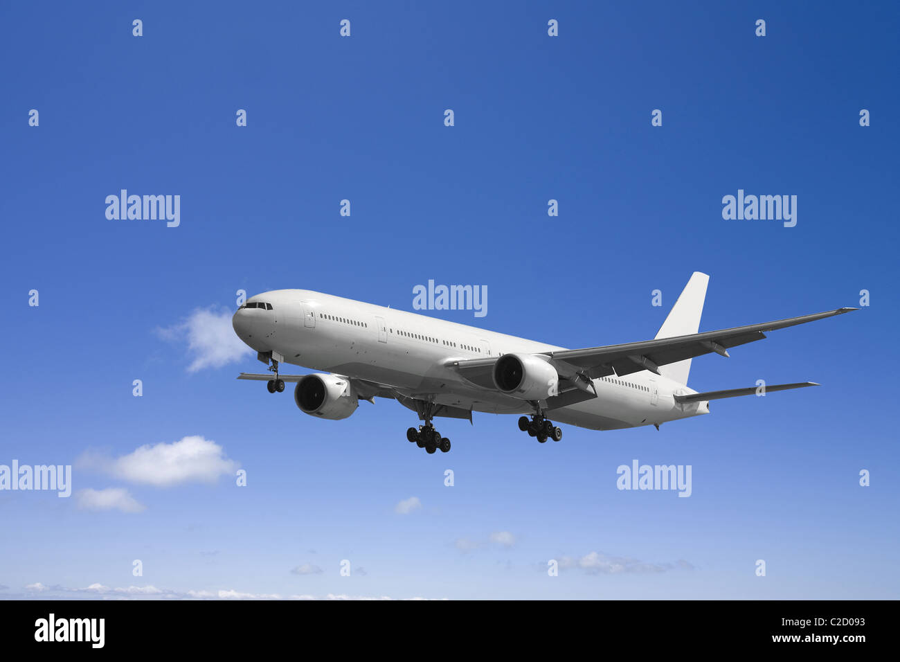 An airplane flying in the blue sky Stock Photo - Alamy