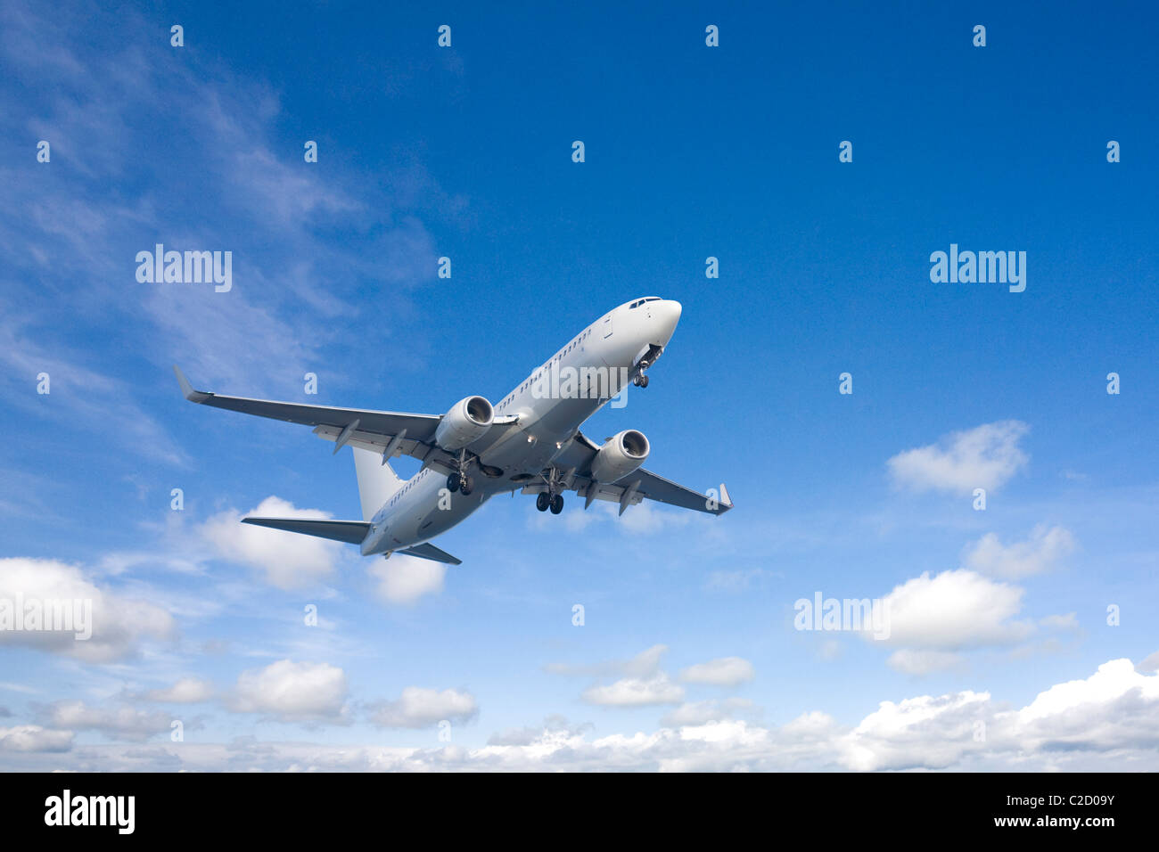 An airplane flying in the blue sky Stock Photo - Alamy