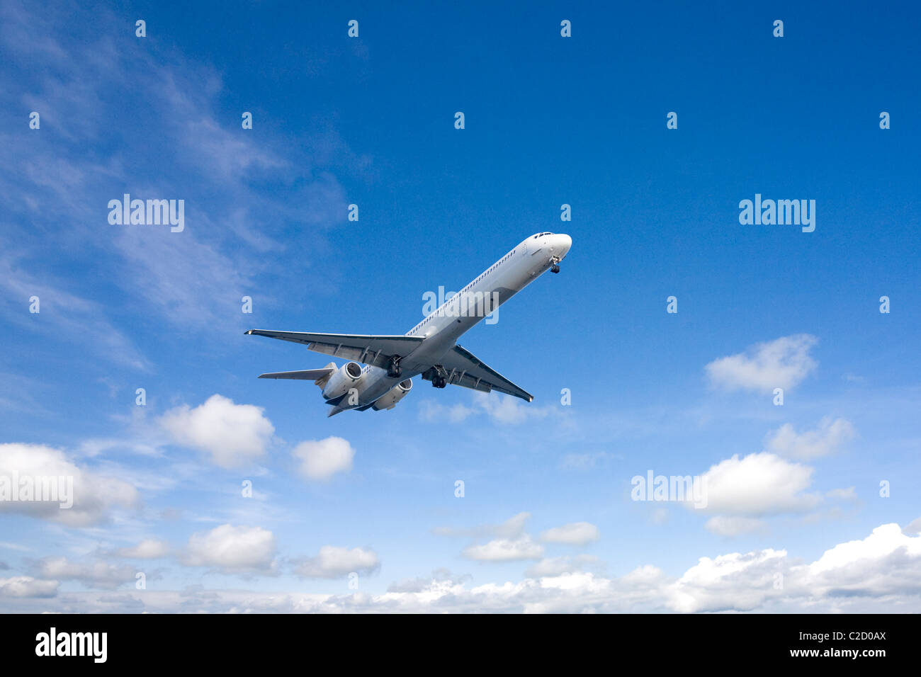 An airplane flying in the blue sky Stock Photo - Alamy