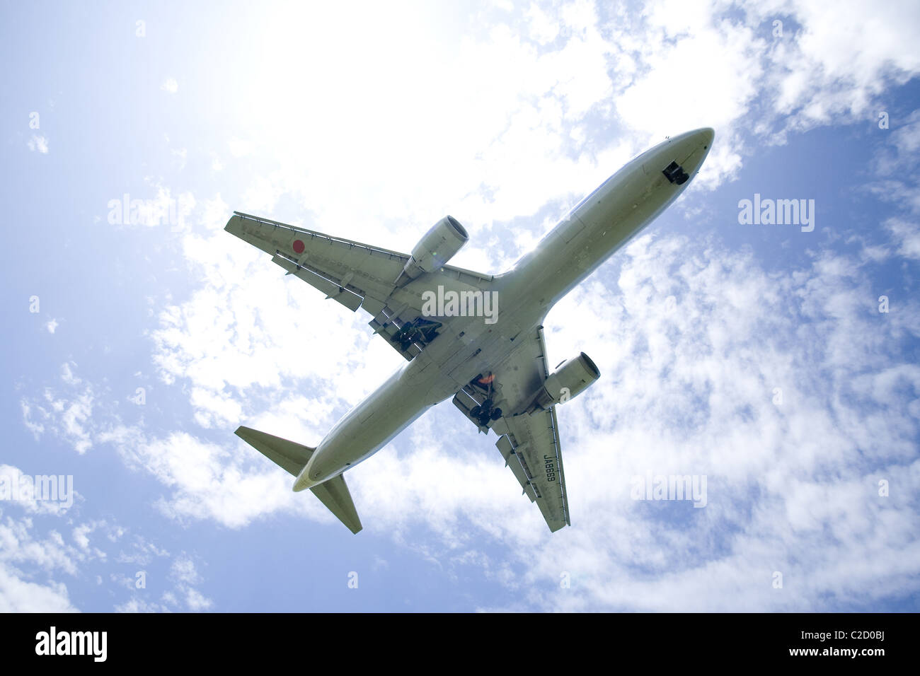An airplane flying in the blue sky Stock Photo - Alamy