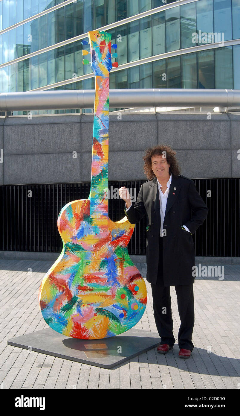 Brian May signs a ten foot Gibson Les Paul Guitar as part of the