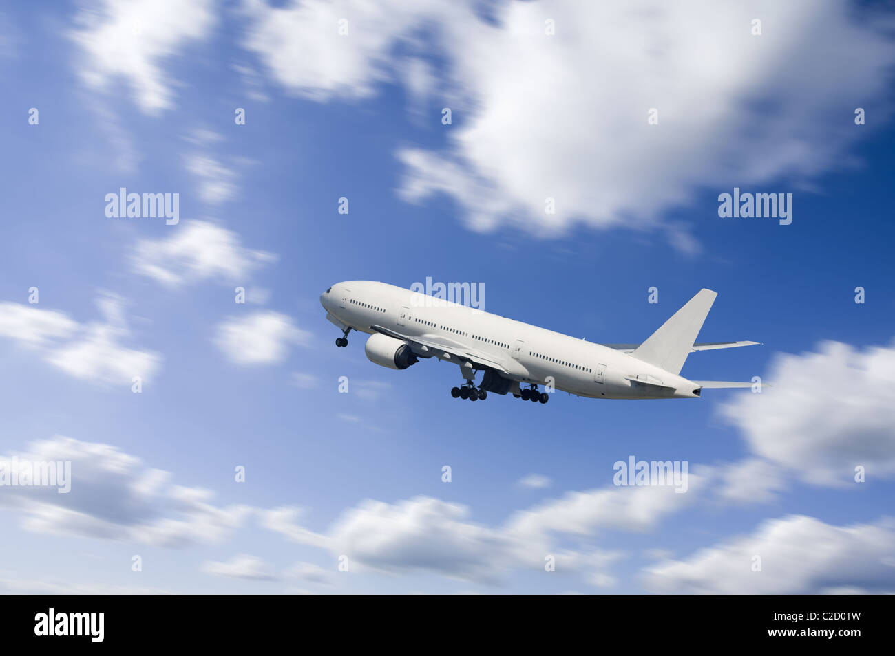 An airplane flying in the blue sky Stock Photo - Alamy