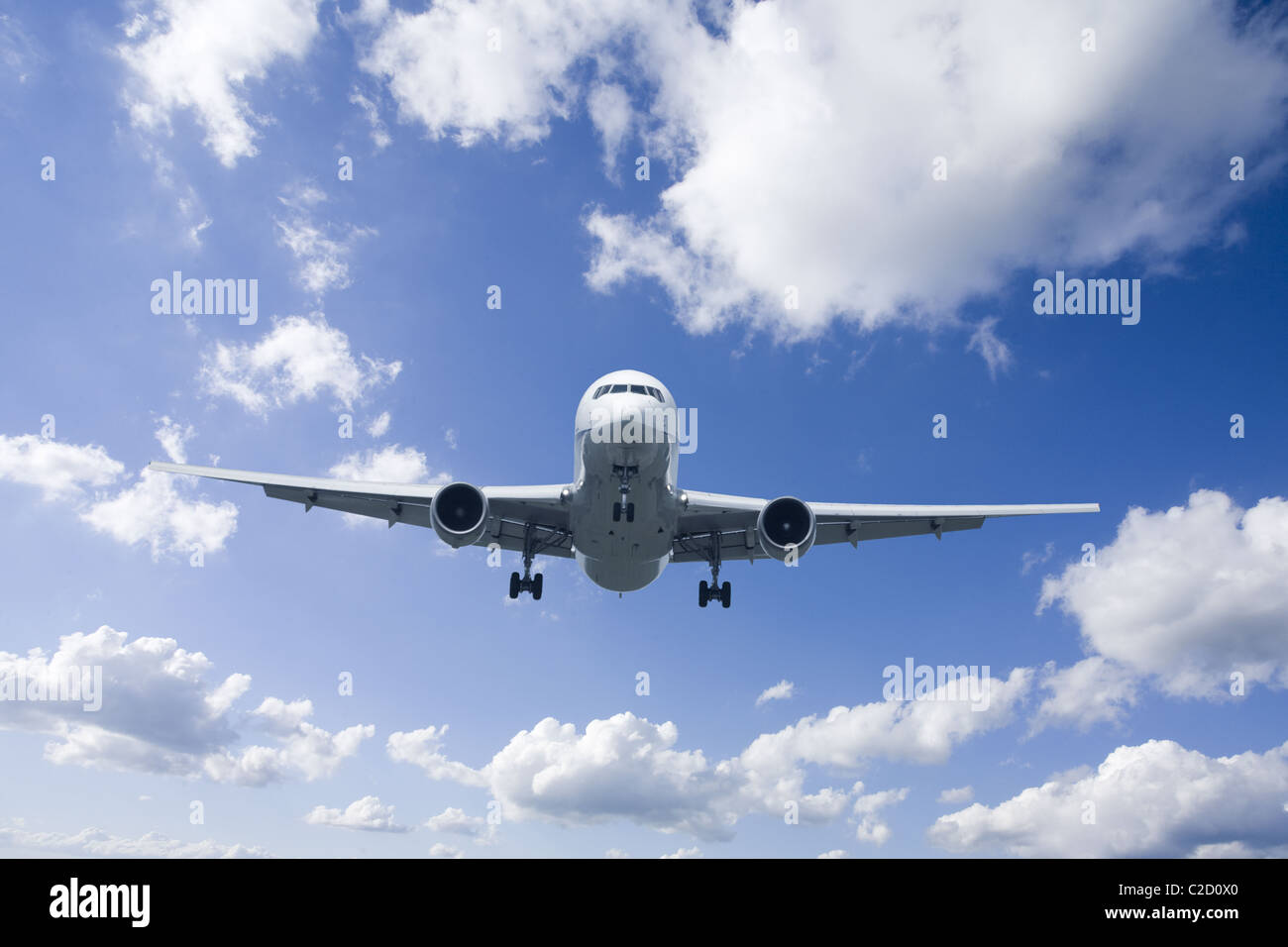 An airplane flying in the blue sky Stock Photo - Alamy