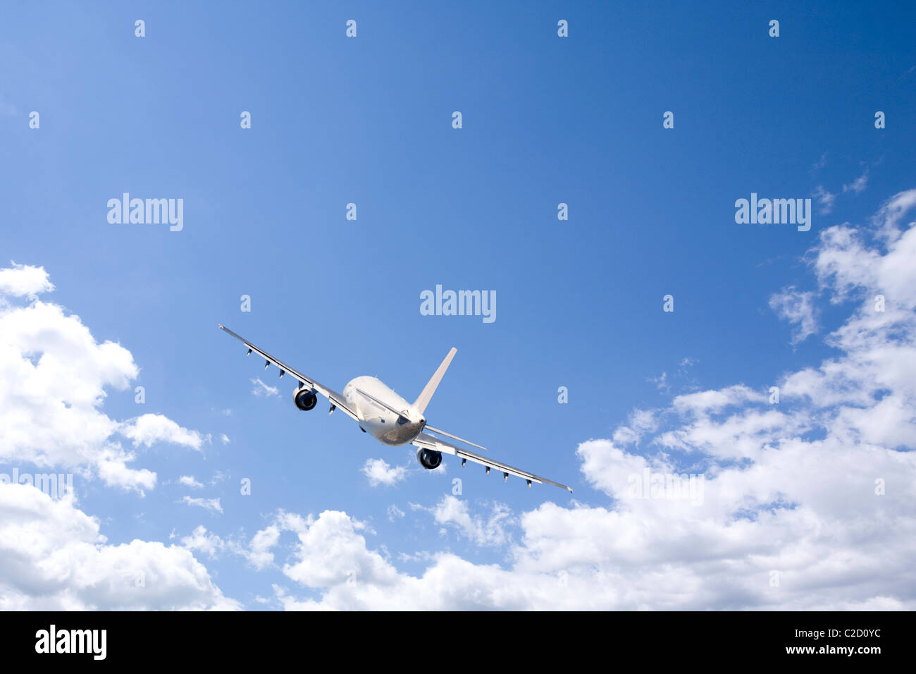 An airplane flying in the blue sky Stock Photo - Alamy