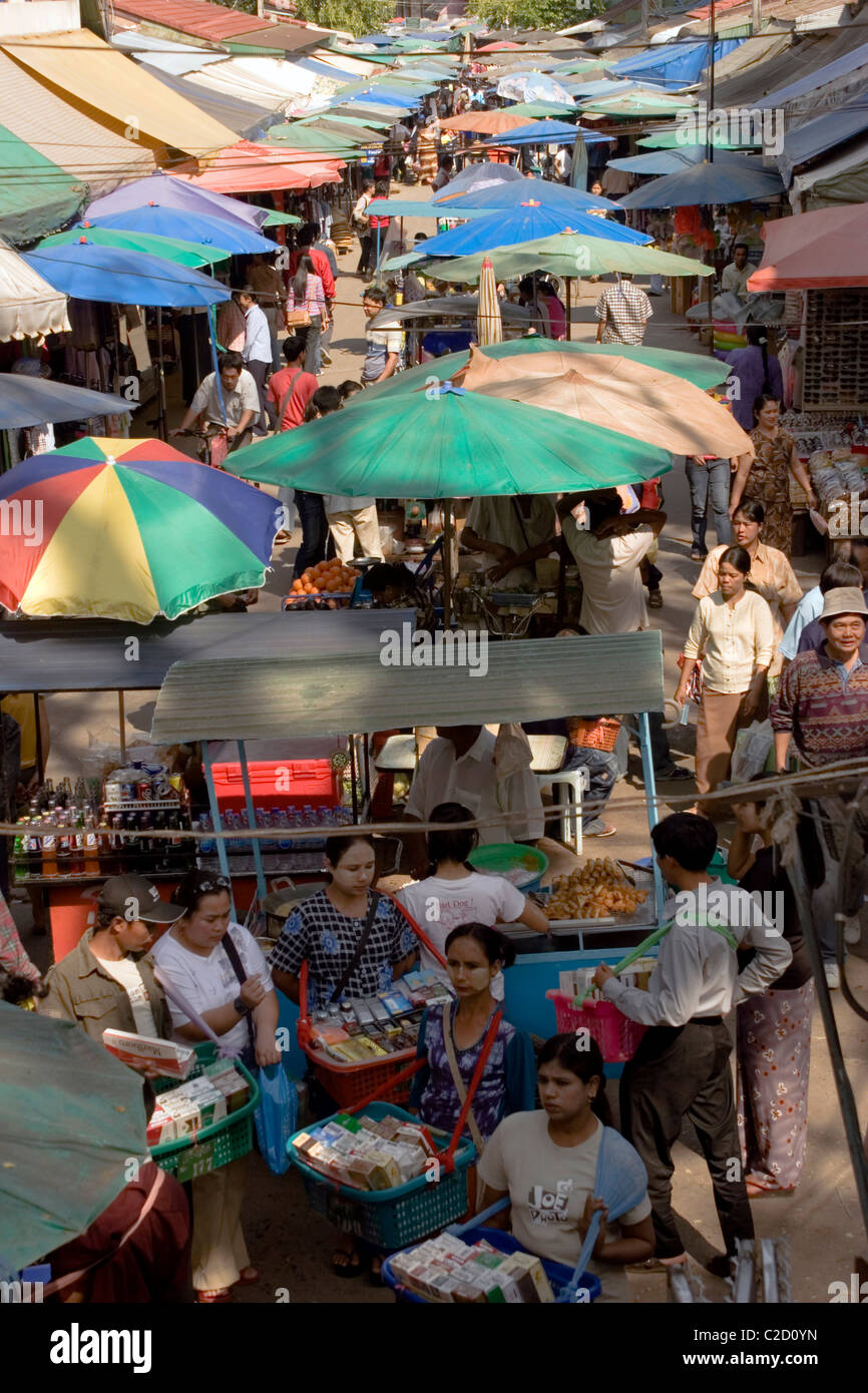 A group of cigarette vendors are selling tobacco products at an outdoor market in